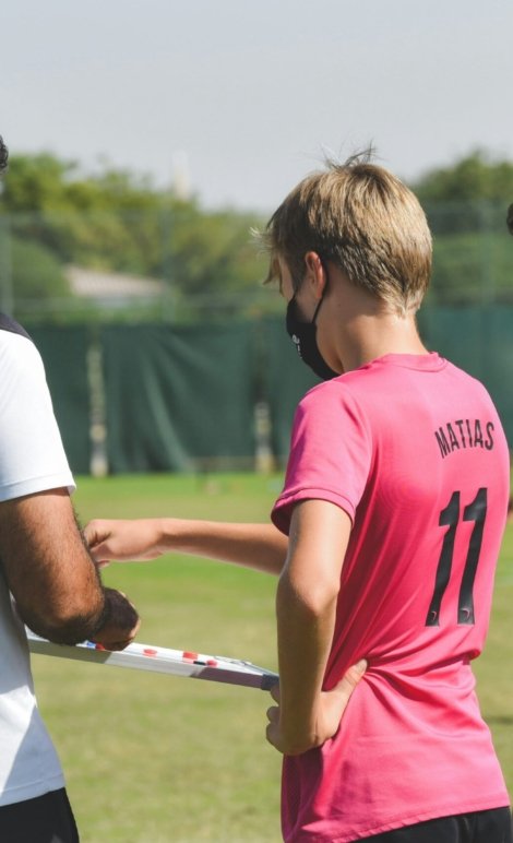man in red nike crew neck t-shirt holding white stick